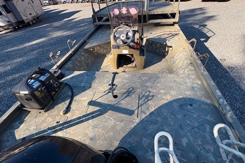 Slide: The Image of 2020 Tracker Grizzly 2072 boat interior with camouflage design and steering console. - 16