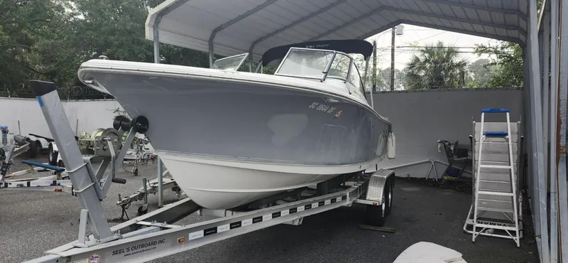 The Image of 2017 Sea Hunt Escape 211 LE boat on trailer under a canopy. - 1