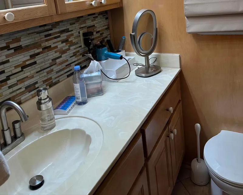 Slide: The Image of Bathroom interior of 2000 Stardust Cruisers 6816 with modern fixtures and accessories. - 11