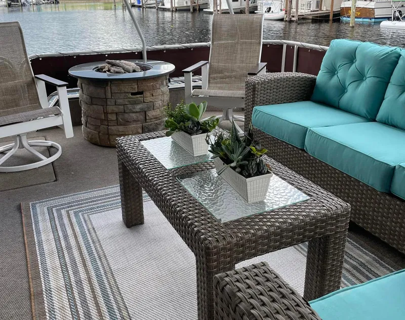 Slide: The Image of Outdoor seating area on a 2000 Stardust Cruisers 6816 houseboat with wicker furniture and lake view. - 13