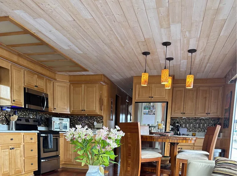 Slide: The Image of Spacious kitchen in 2000 Stardust Cruisers 6816 with wooden cabinets and modern appliances. - 3