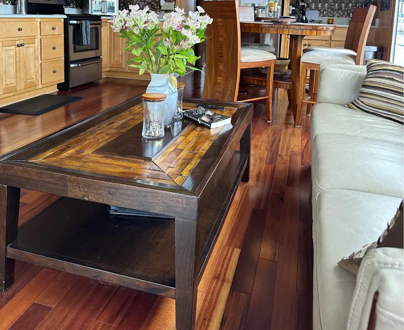 Slide: The Image of Luxurious houseboat interior with wooden flooring, elegant furniture, and floral centerpiece. Stardust Cruisers 6816, 2000. - 4