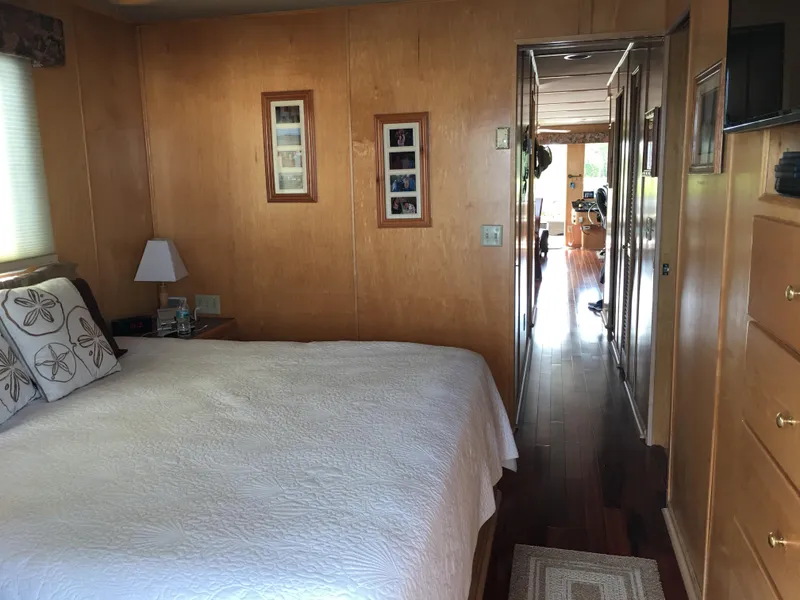 Slide: The Image of Bedroom interior of 2000 Stardust Cruisers 6816 houseboat with wood paneling and cozy decor. - 5