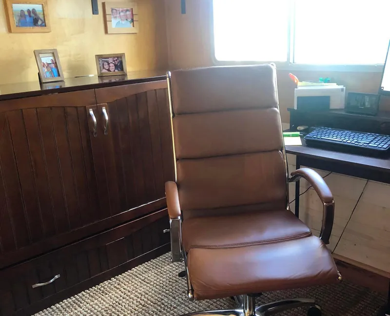 Slide: The Image of Office chair in a cozy room with wooden furniture and family photos. - 6