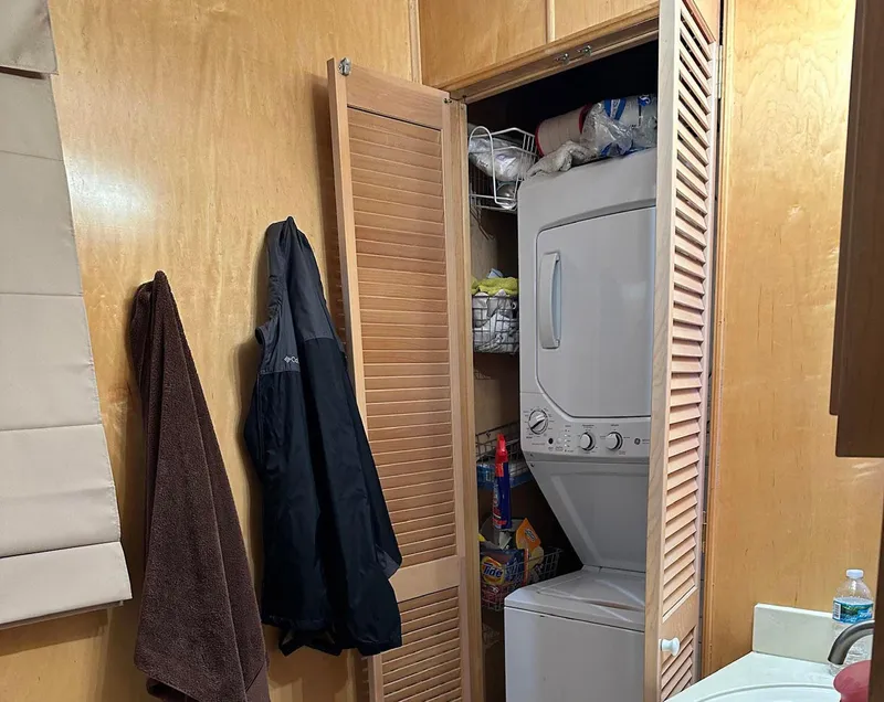 Slide: The Image of Compact laundry area with stacked washer-dryer in a 2000 Stardust Cruisers 6816. - 7