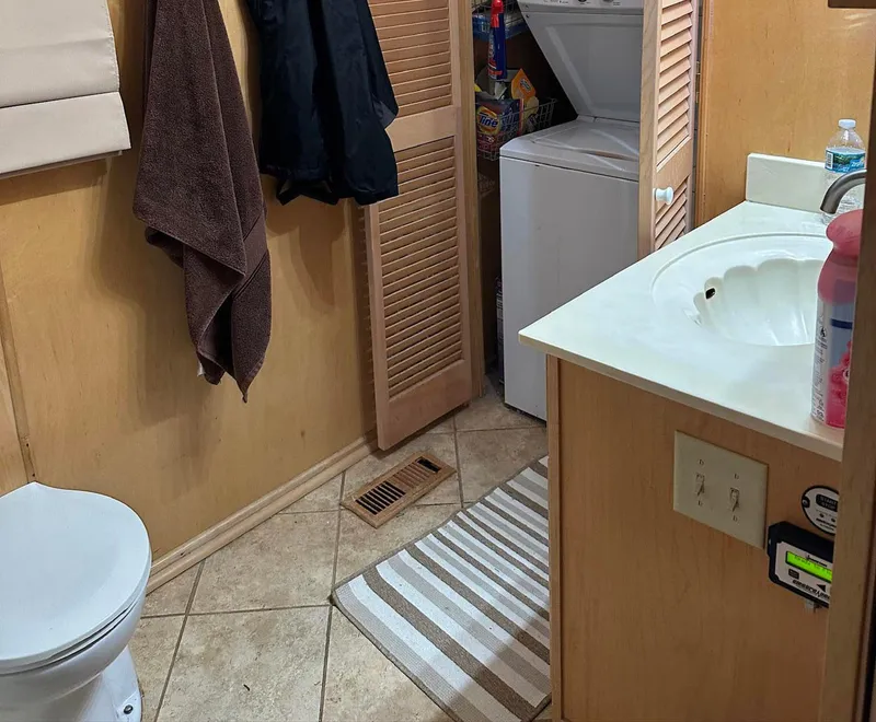 Slide: The Image of Bathroom in 2000 Stardust Cruisers 6816 with washer, sink, and toilet. - 8