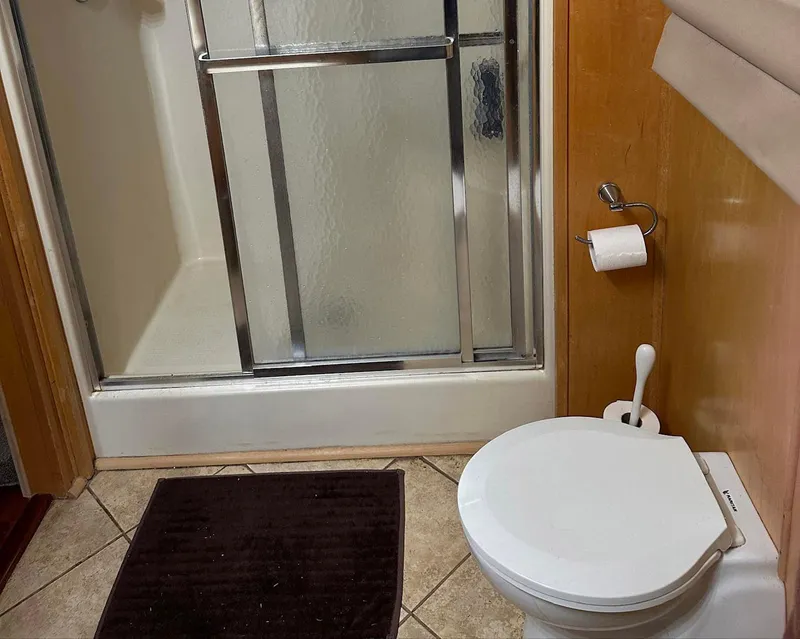 Slide: The Image of Bathroom with shower and toilet in 2000 Stardust Cruisers 6816 houseboat. - 9