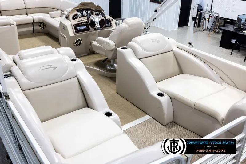 Slide: The Image of 2013 Bennington 2375 GCW pontoon boat interior with luxurious seating and modern dashboard. - 11