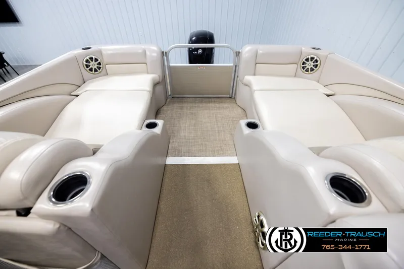 Slide: The Image of 2013 Bennington 2375 GCW pontoon boat interior with beige seating and cup holders. - 15
