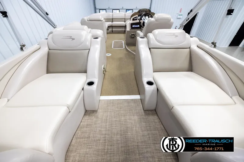Slide: The Image of 2013 Bennington 2375 GCW pontoon boat interior with beige seating and carpet. - 16
