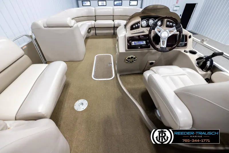 Slide: The Image of 2013 Bennington 2375 GCW boat interior with plush seating and modern dashboard. - 17
