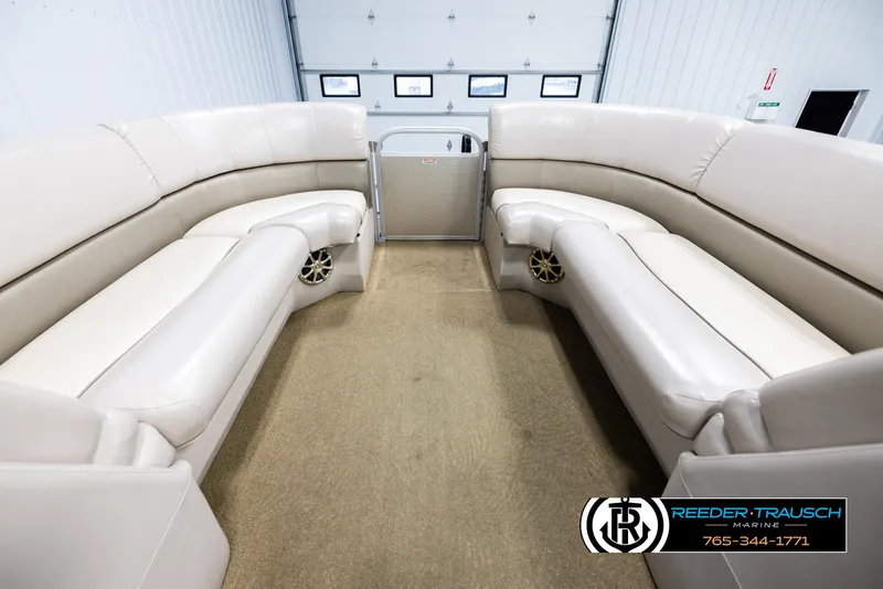 Slide: The Image of 2013 Bennington 2375 GCW pontoon boat interior with beige seating and carpet flooring. - 20