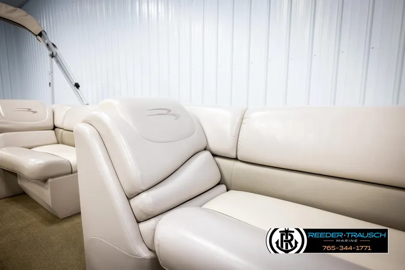 Slide: The Image of 2013 Bennington 2375 GCW boat interior with beige leather seating, Reeder-Trausch Marine logo. - 22