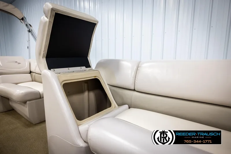 Slide: The Image of Open storage compartment in 2013 Bennington 2375 GCW boat interior, beige seating. - 23