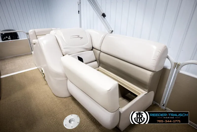 Slide: The Image of 2013 Bennington 2375 GCW boat interior with beige seating and storage compartment. - 28