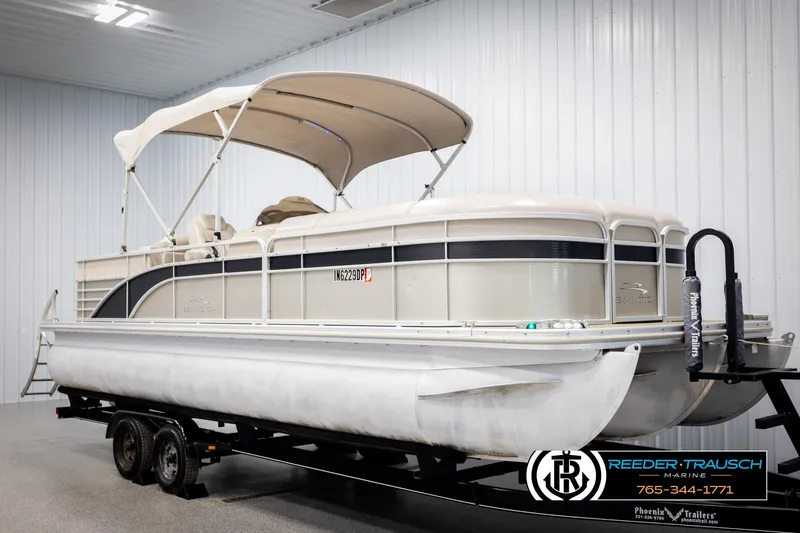 Slide: The Image of 2013 Bennington 2375 GCW pontoon boat on trailer in indoor storage. - 3