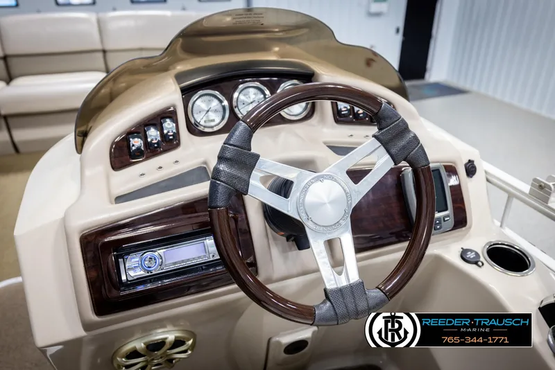 Slide: The Image of Steering console of 2013 Bennington 2375 GCW boat with wood accents and modern controls. - 30