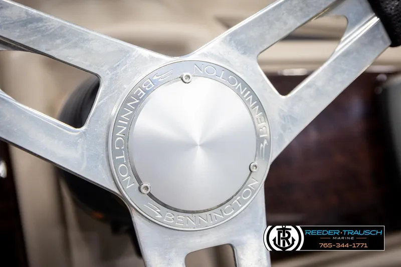Slide: The Image of Steering wheel of 2013 Bennington 2375 GCW boat, featuring Reeder-Trausch Marine logo. - 31