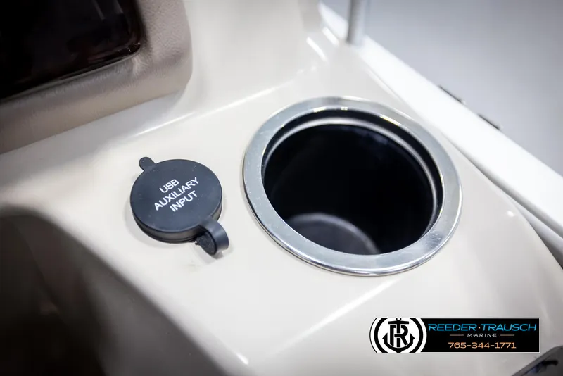 Slide: The Image of USB auxiliary input and cup holder on 2013 Bennington 2375 GCW boat console. - 38