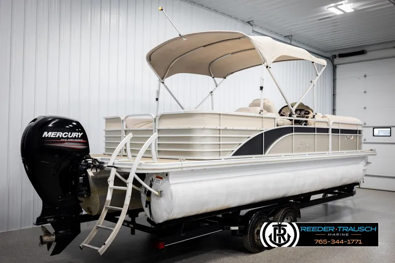 Slide: The Image of 2013 Bennington 2375 GCW pontoon boat with Mercury outboard motor in a showroom. - 6