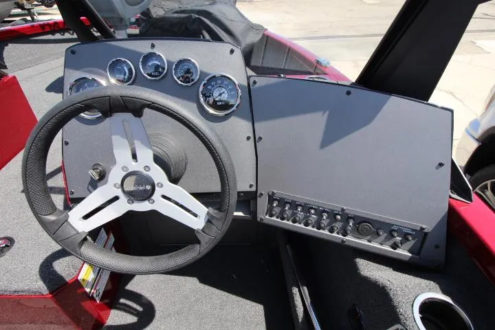 Slide: The Image of 2025 Vexus ADX180LS boat dashboard with steering wheel and control panel. - 4