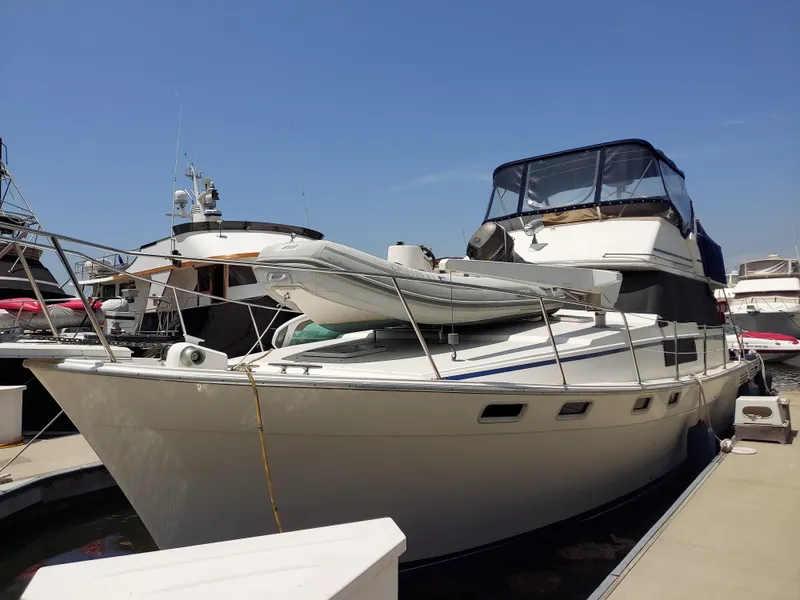 The Image of 1987 Bayliner 3870 Motoryacht docked, featuring sleek design and spacious deck. - 0