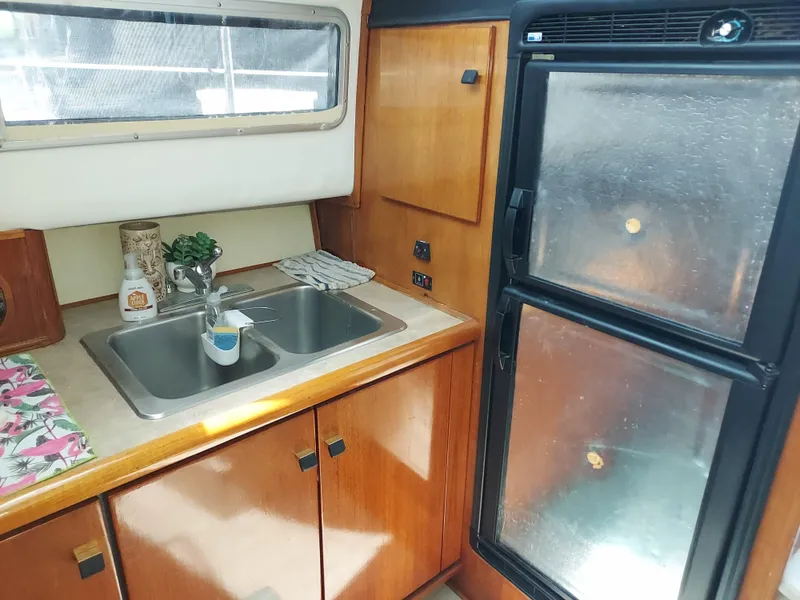 Slide: The Image of 1987 Bayliner 3870 Motoryacht kitchen with double sink and refrigerator. - 11