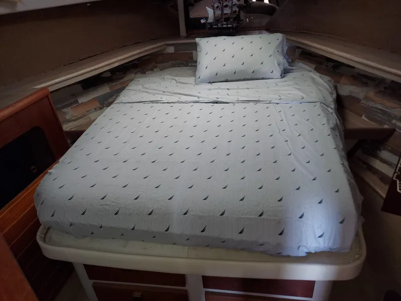 Slide: The Image of Cozy bedroom in 1987 Bayliner 3870 Motoryacht with nautical-themed bedding. - 12