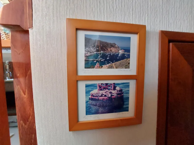 Slide: The Image of Framed nautical photos on a Bayliner 3870 Motoryacht, 1987 model, interior wall. - 21