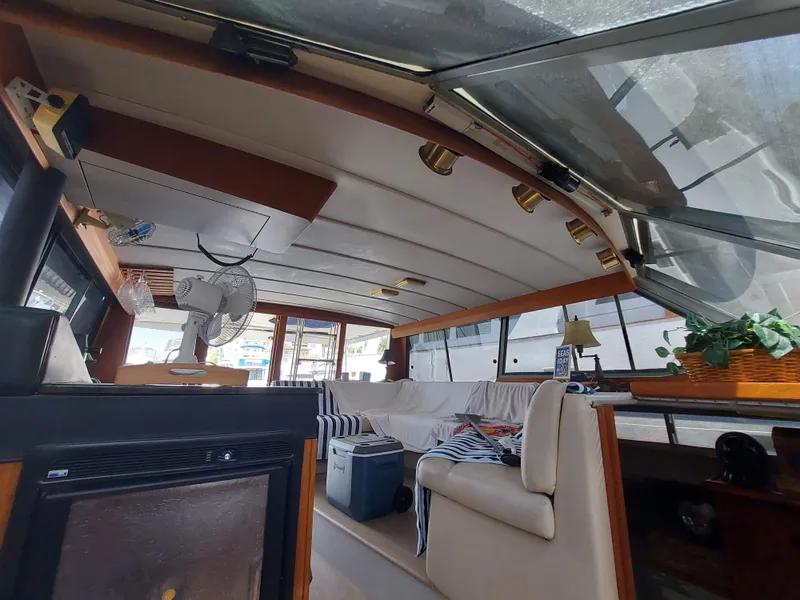 Slide: The Image of Interior of 1987 Bayliner 3870 Motoryacht with seating, fan, and decor elements. - 22