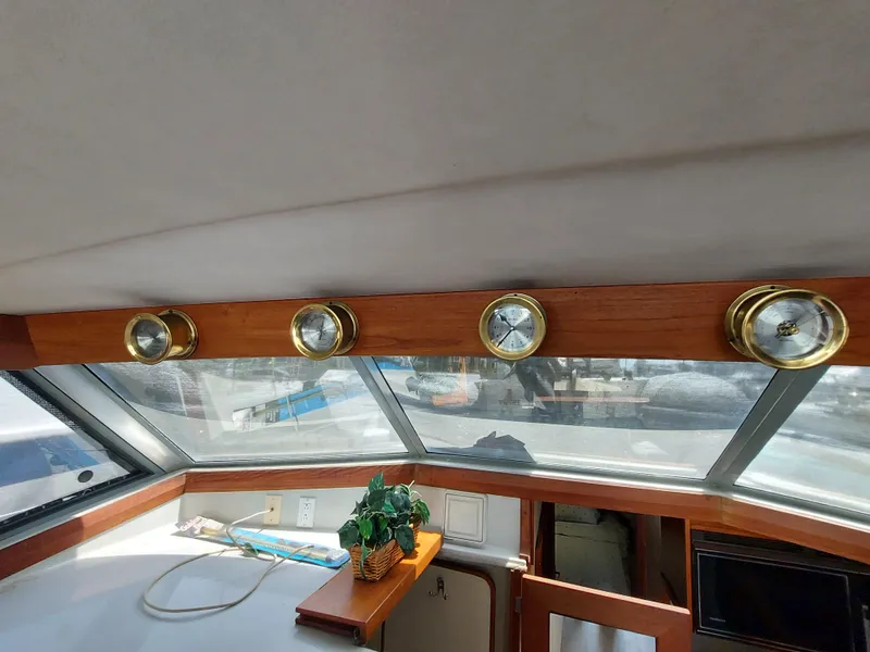 Slide: The Image of 1987 Bayliner 3870 Motoryacht interior with gauges and panoramic windows. - 23