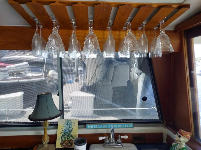 Slide: The Image of Interior of 1987 Bayliner 3870 Motoryacht with hanging glasses and decorative items. - 24