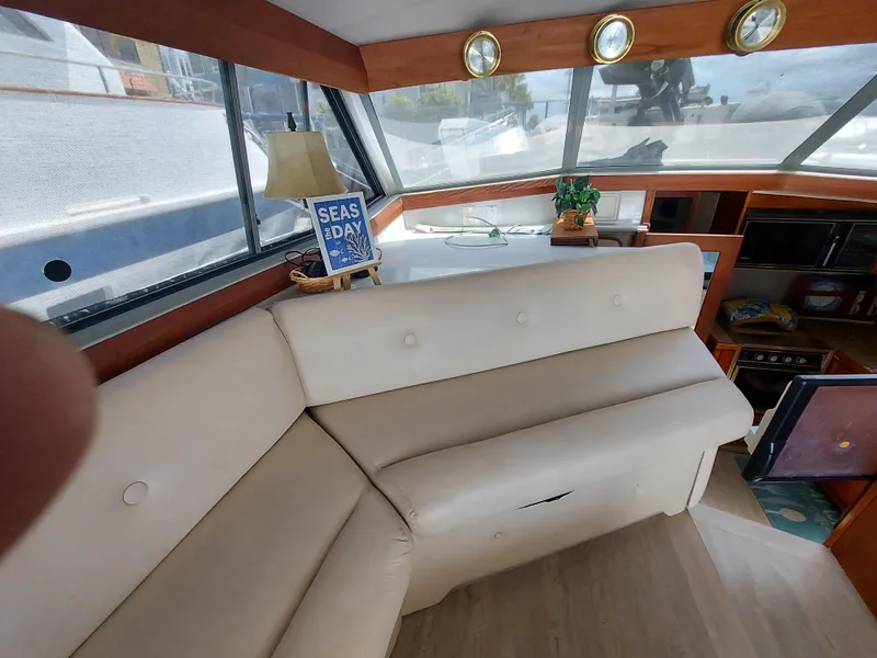 Slide: The Image of Interior of 1987 Bayliner 3870 Motoryacht with beige seating and nautical decor. - 7