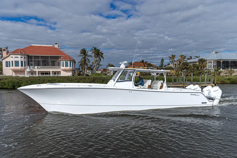 The Image of 2026 Front Runner 43 Catamaran cruising on a scenic waterway near waterfront homes. - 0