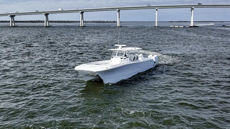 Slide: The Image of 2026 Front Runner 43 Catamaran cruising on water near a bridge. - 6