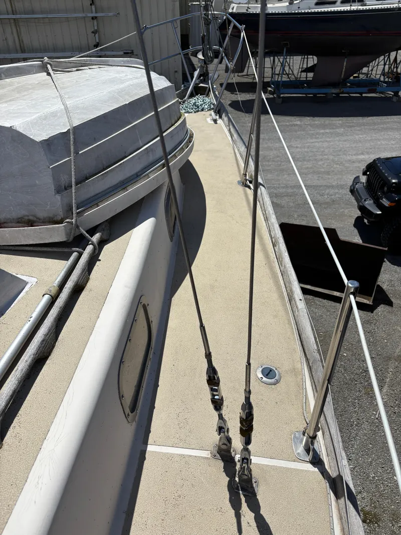 Slide: The Image of 1972 Tartan 34C sailboat deck with rigging and fittings in a boatyard. - 13