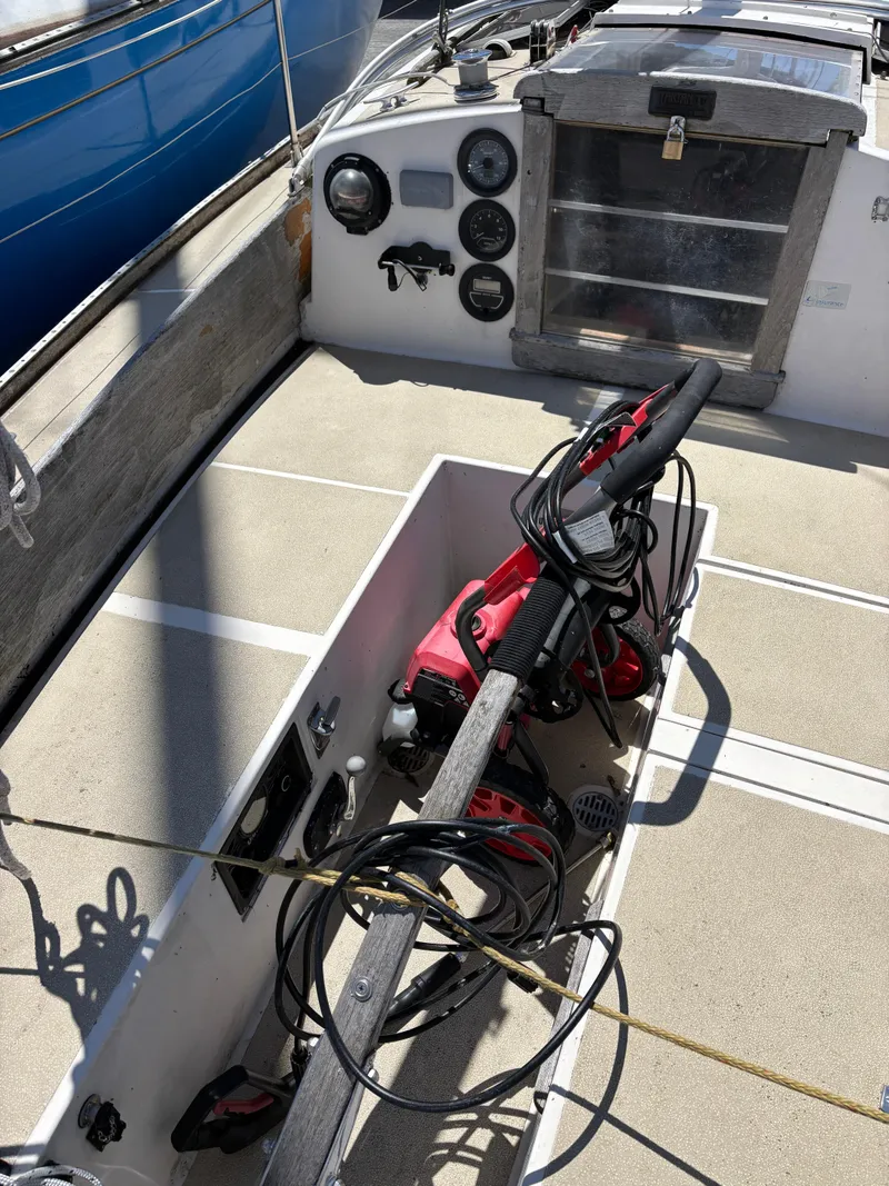 Slide: The Image of 1972 Tartan 34C sailboat cockpit with steering wheel and control panel. - 17