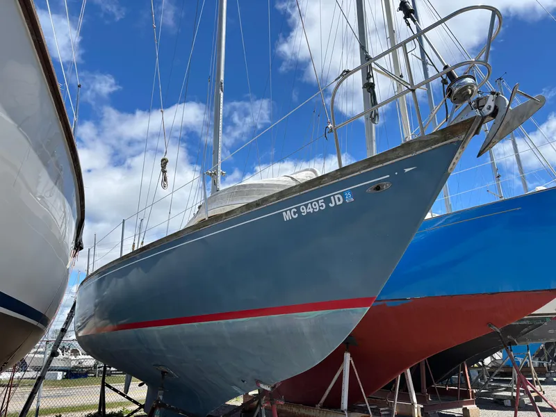 Slide: The Image of 1972 Tartan 34C sailboat on dry dock under a clear blue sky. - 2