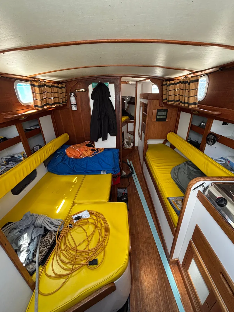 Slide: The Image of Interior of a 1972 Tartan 34C sailboat with yellow cushions and wooden accents. - 24