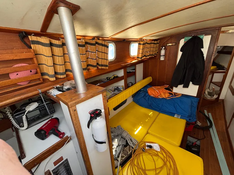 Slide: The Image of Interior of a 1972 Tartan 34C sailboat with yellow seating and nautical equipment. - 26