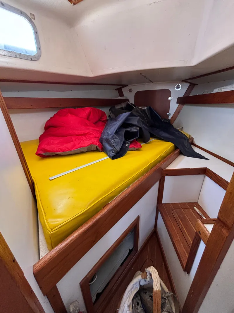 Slide: The Image of Interior of a 1972 Tartan 34C sailboat with yellow cushion and red jacket. - 34