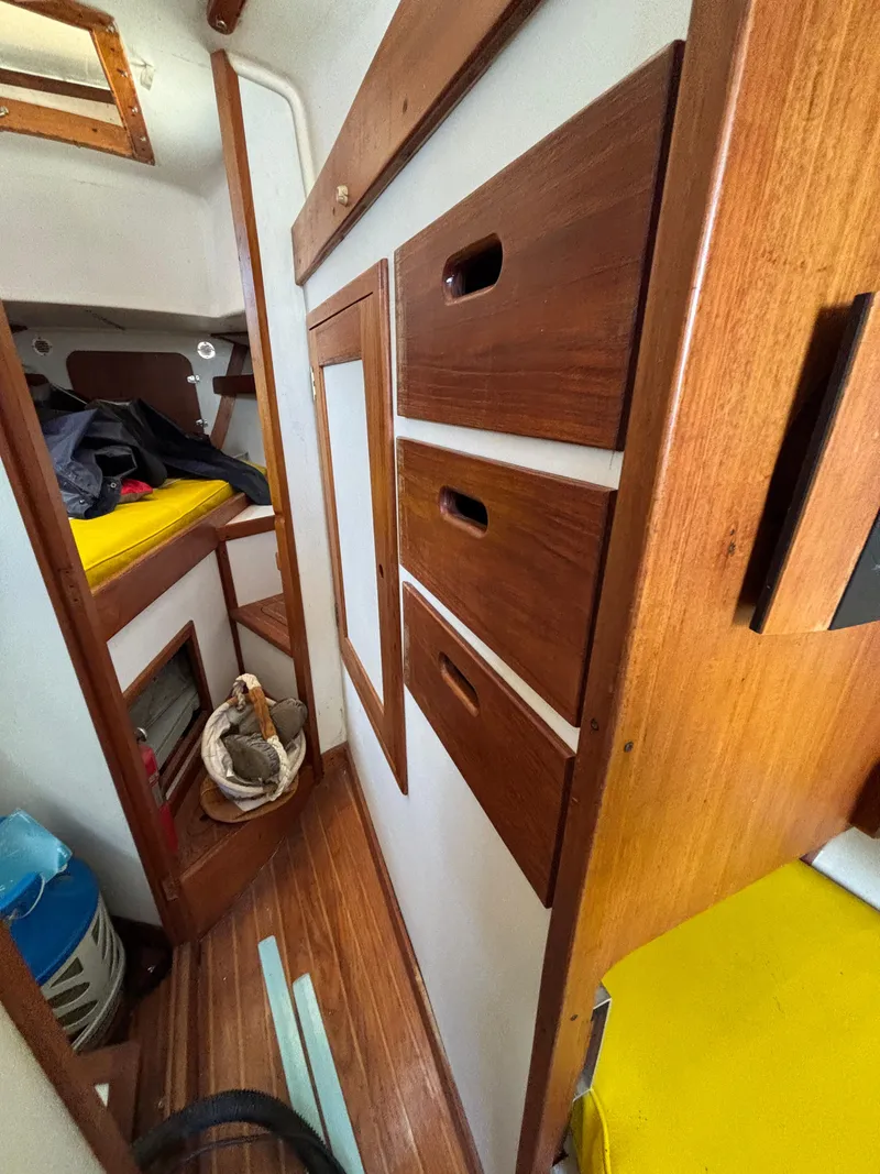 Slide: The Image of Interior of a 1972 Tartan 34C sailboat with wooden cabinetry and yellow cushions. - 35