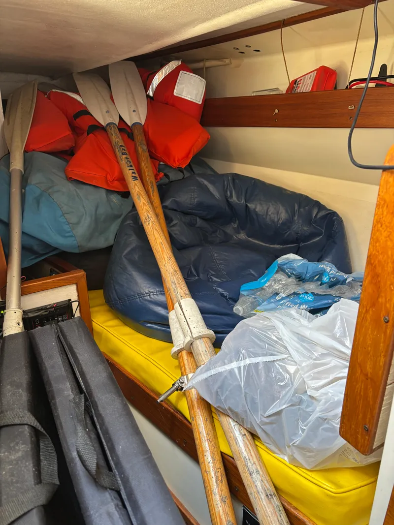 Slide: The Image of Interior of a 1972 Tartan 34C sailboat with oars, life jackets, and cushions. - 37