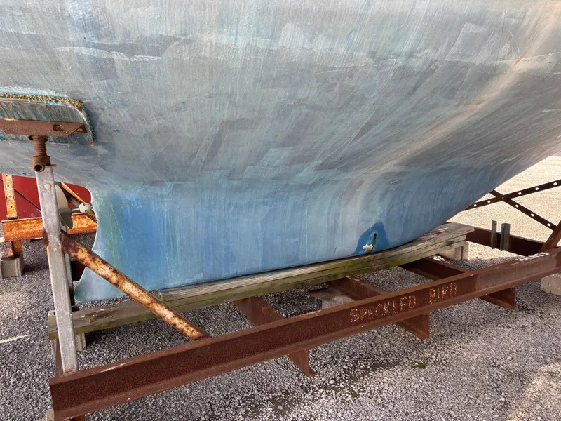 Slide: The Image of Hull of a 1972 Tartan 34C sailboat on a rusty metal stand. - 4