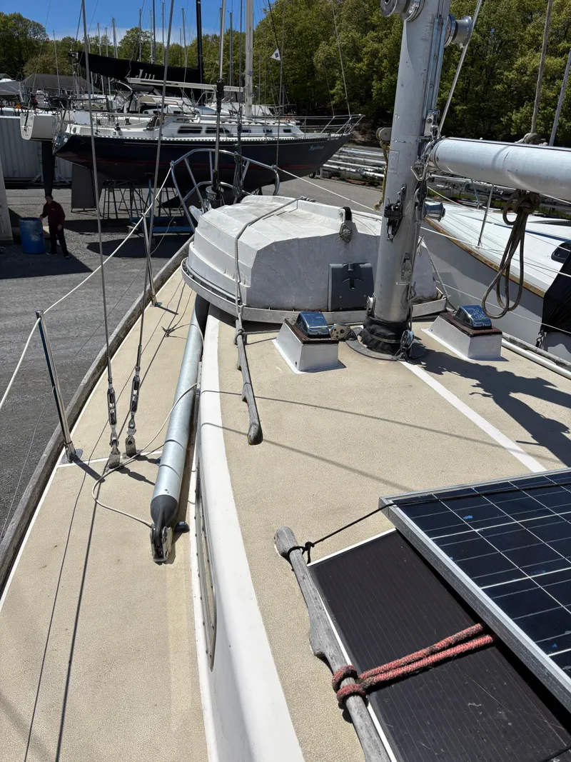 Slide: The Image of 1972 Tartan 34C sailboat deck with solar panel, docked in a marina. - 6