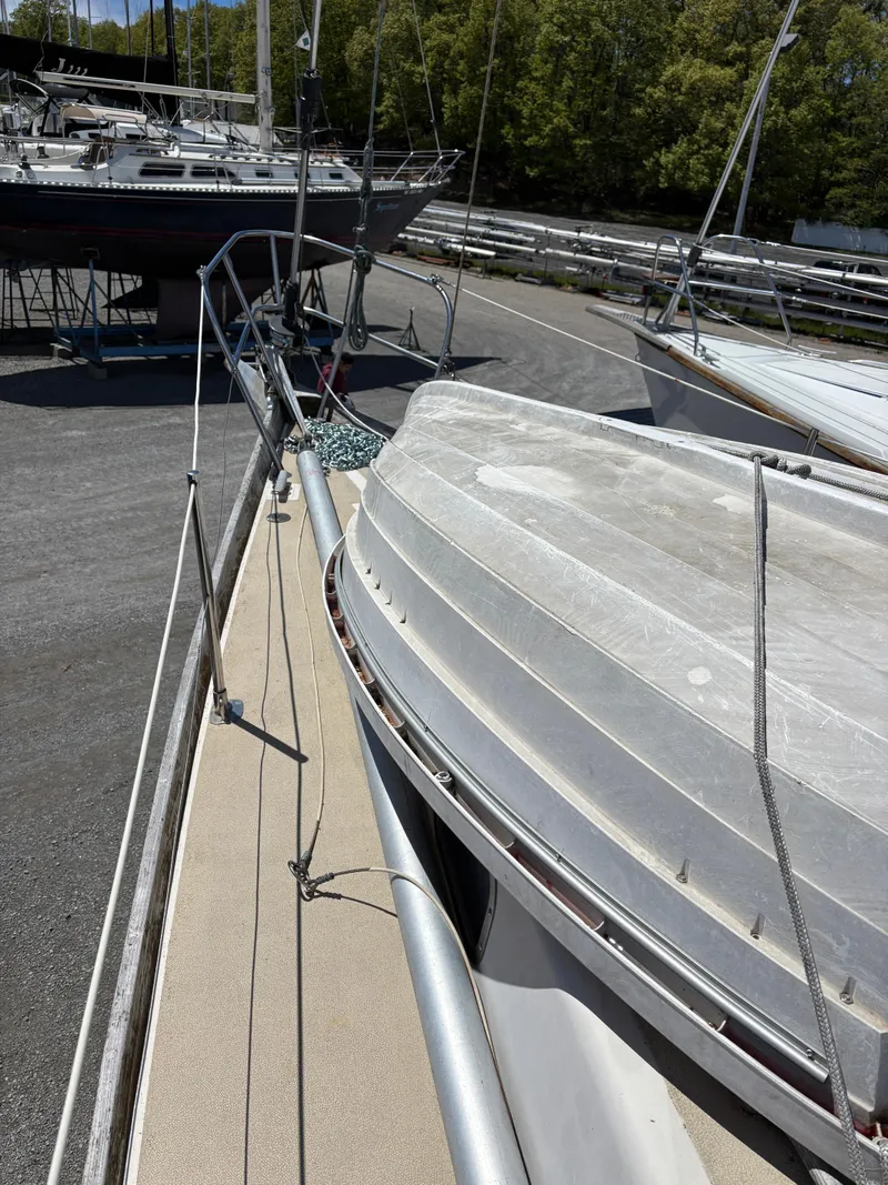 Slide: The Image of 1972 Tartan 34C sailboat on dry dock, surrounded by other boats. - 7