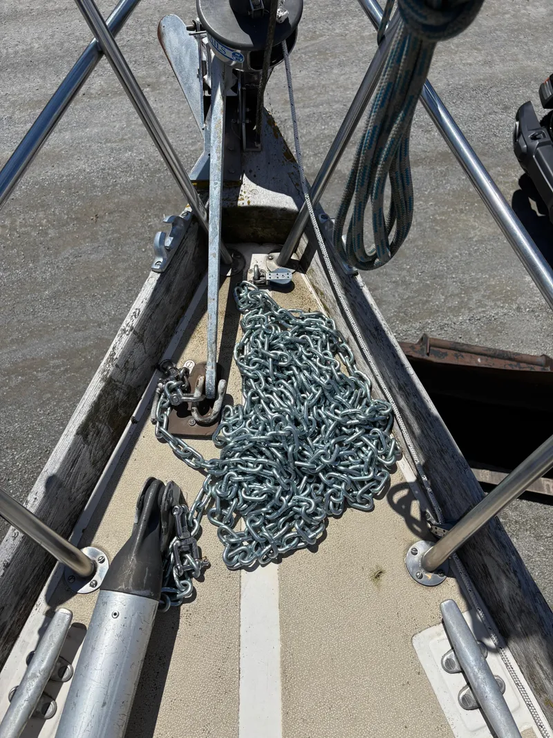 Slide: The Image of Anchor chain on a 1972 Tartan 34C sailboat deck, with metal railing and winch. - 9