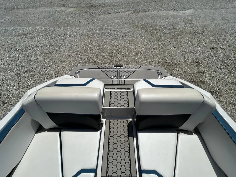 Slide: The Image of 2019 Scarab 215 ID boat interior with white seating and hexagonal floor design. - 14