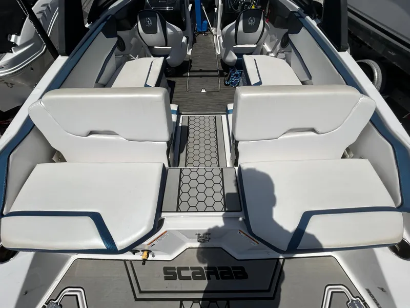 Slide: The Image of 2019 Scarab 215 ID boat interior with white seating and hexagonal floor design. - 15