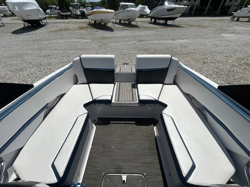 Slide: The Image of 2019 Scarab 215 ID boat interior with white seating and gray flooring. - 5